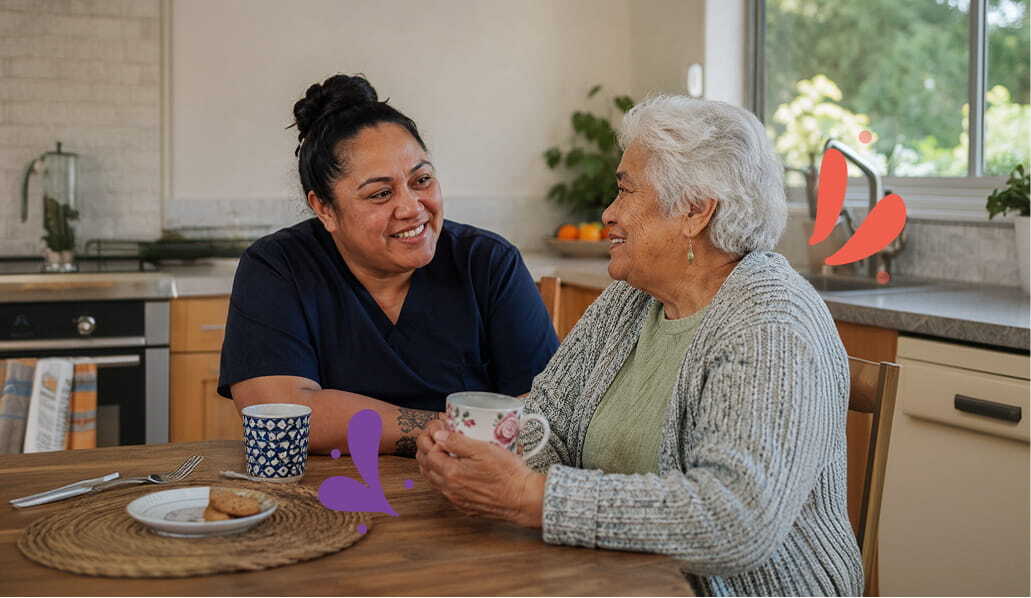 Carer and elderly woman having a cup of tea