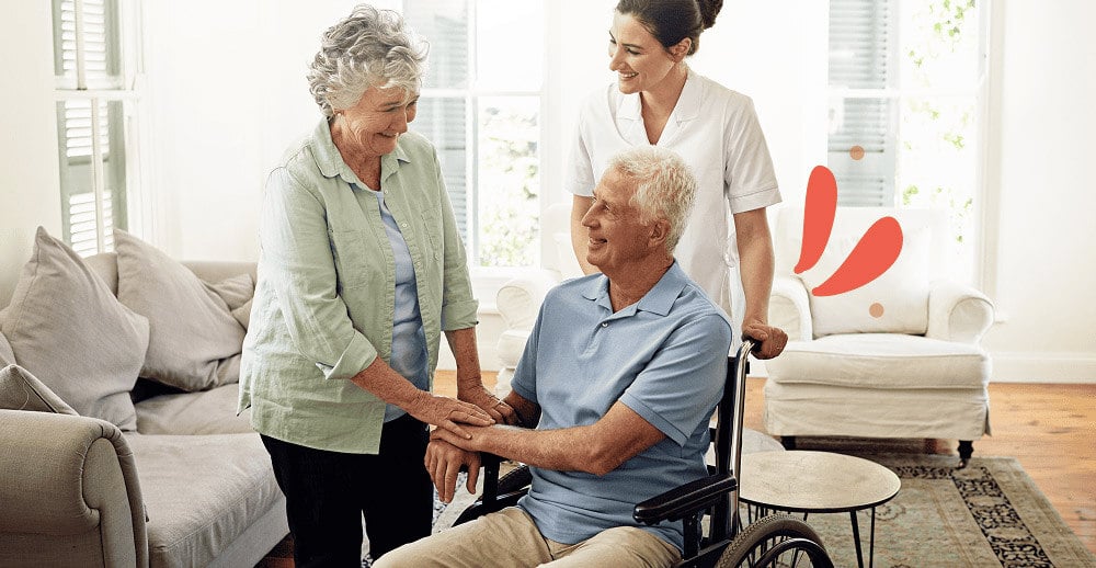 Caregiver providing companionship to an elderly couple at home