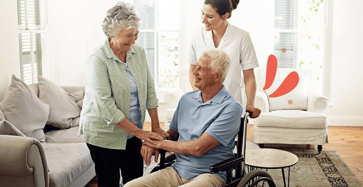 Caregiver providing companionship to an elderly couple at home
